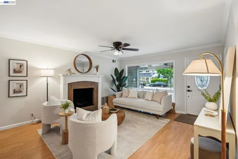 a living room with furniture a clock and a fireplace