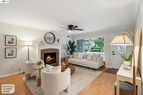a living room with furniture a fireplace and a chandelier