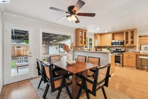 a view of a dining room with furniture and a kitchen
