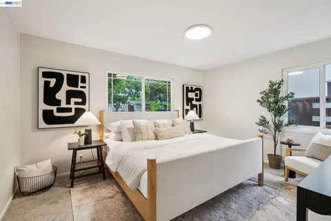 a bedroom with a bed and a lamp with window