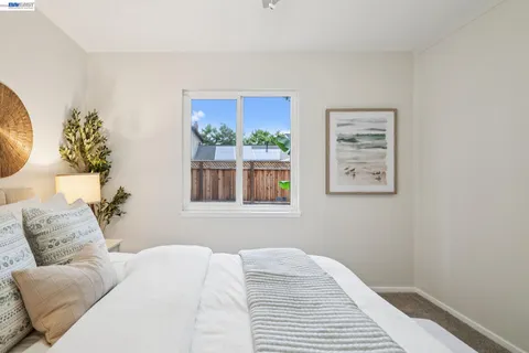 a bedroom with a bed and a mirror