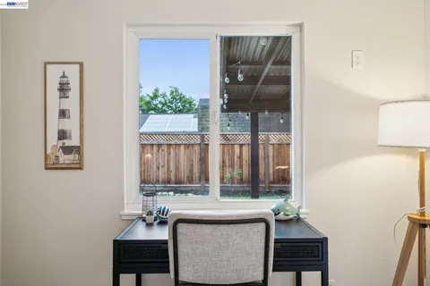 a view of a porch with furniture and a yard