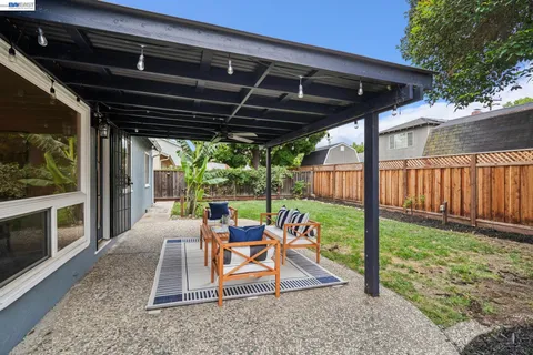 a view of a house with backyard porch and sitting area