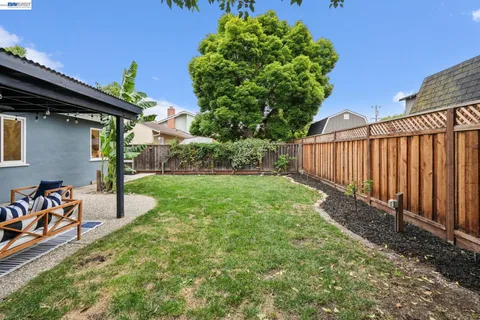 a view of a house with backyard and sitting area