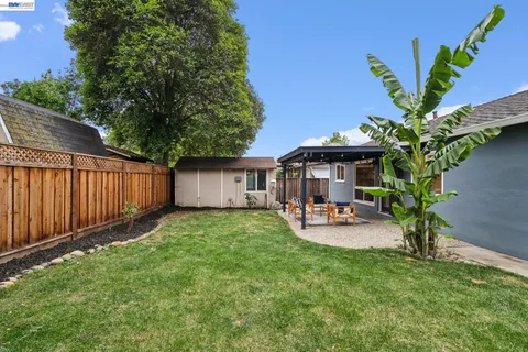 a view of a backyard with table and chairs and a fire pit