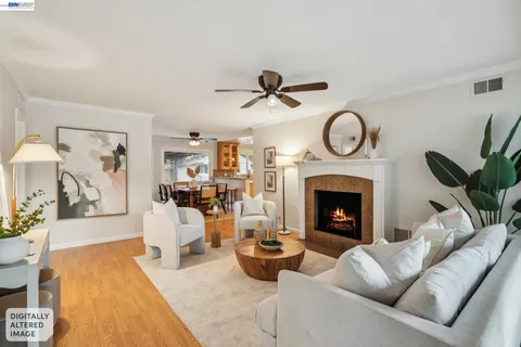 a living room with furniture a clock and a fireplace
