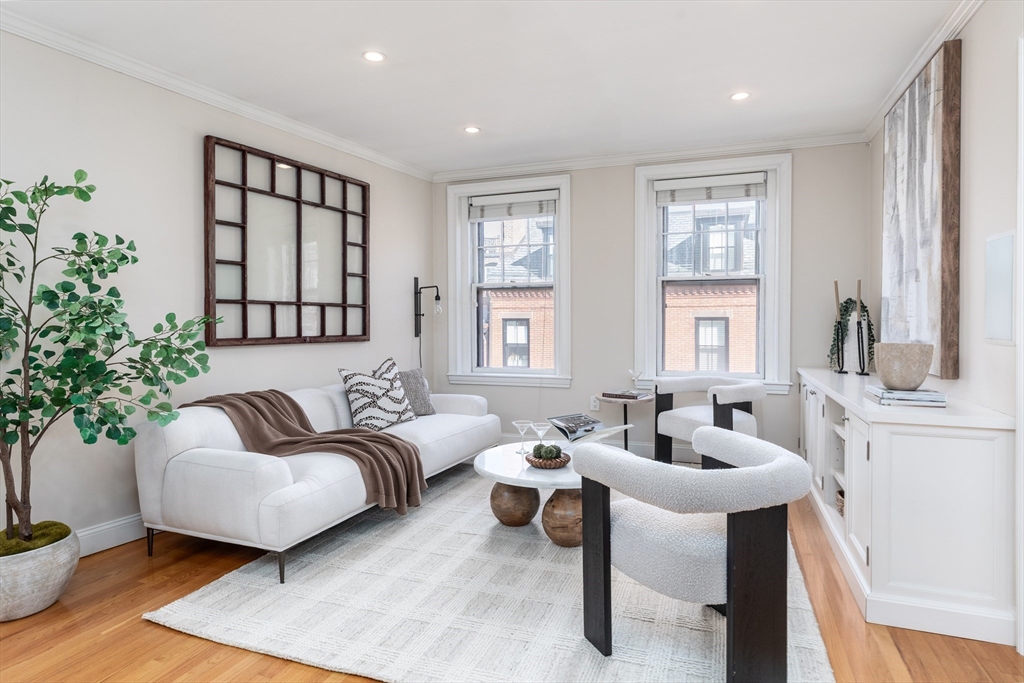 76 West Cedar Street, Unit 4F Boston, MA 02114 - Photo 1 of 22 a living room with furniture and a potted plant