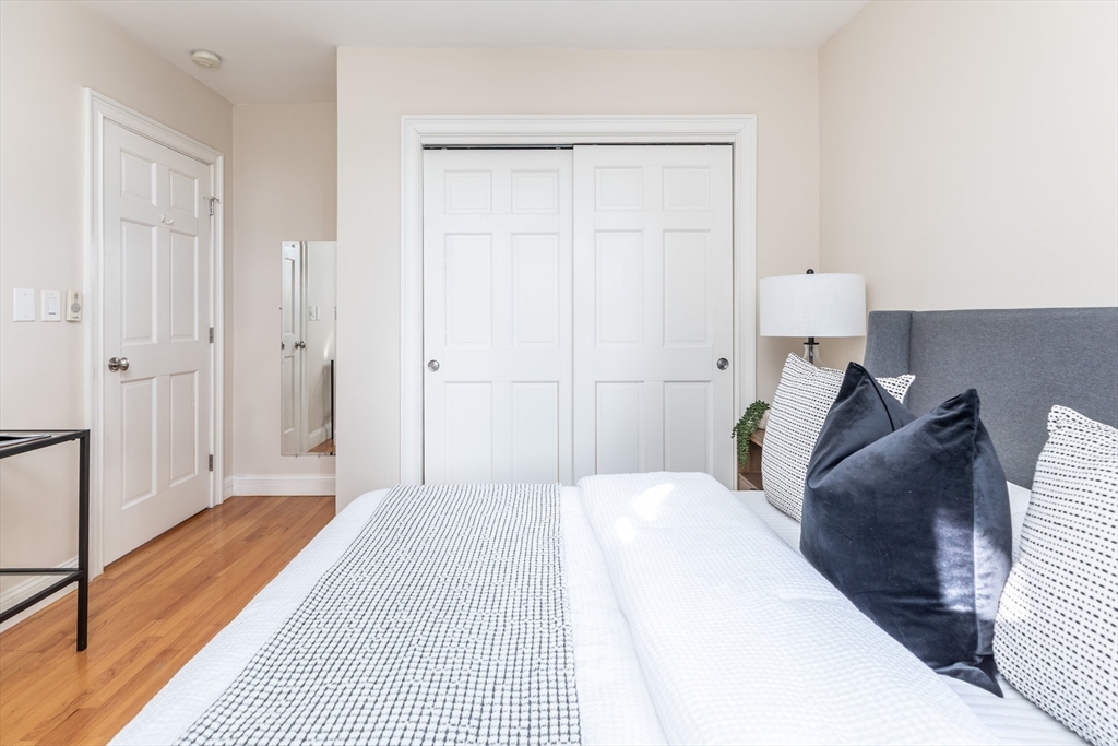 76 West Cedar Street, Unit 4F Boston, MA 02114 - Photo 13 of 22 a bedroom with a bed and a walk in closet