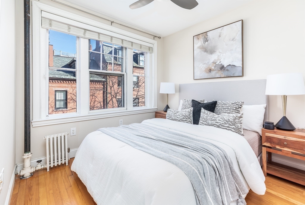 76 West Cedar Street, Unit 4F Boston, MA 02114 - Photo 17 of 22 a bedroom with a large bed and a window