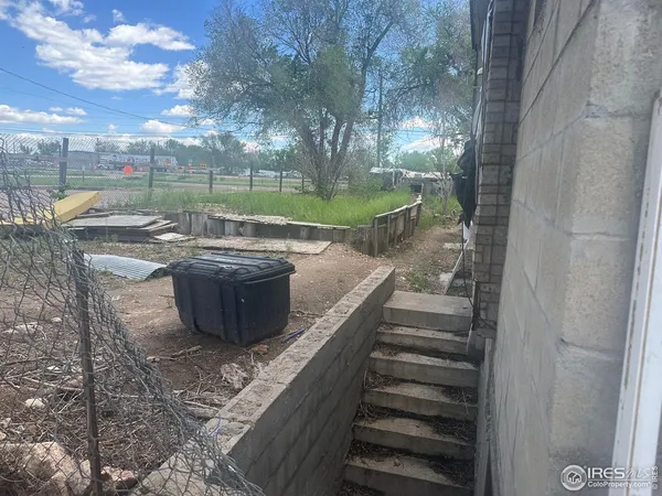 a view of a backyard with wooden fence