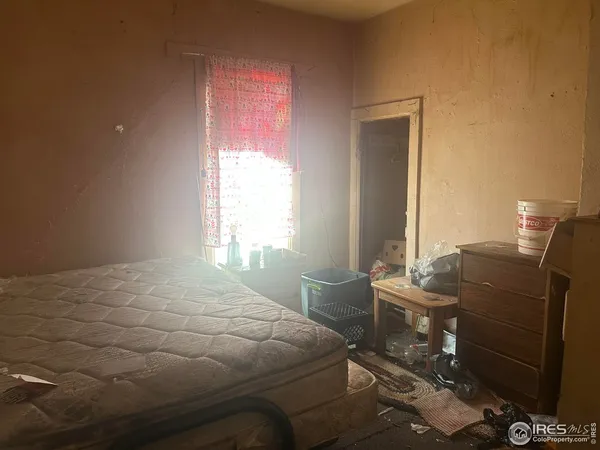 a bedroom with a bed and windows