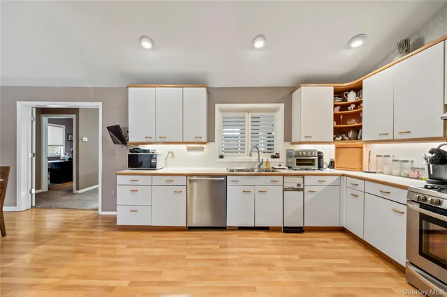 a kitchen with stainless steel appliances granite countertop a stove and cabinets