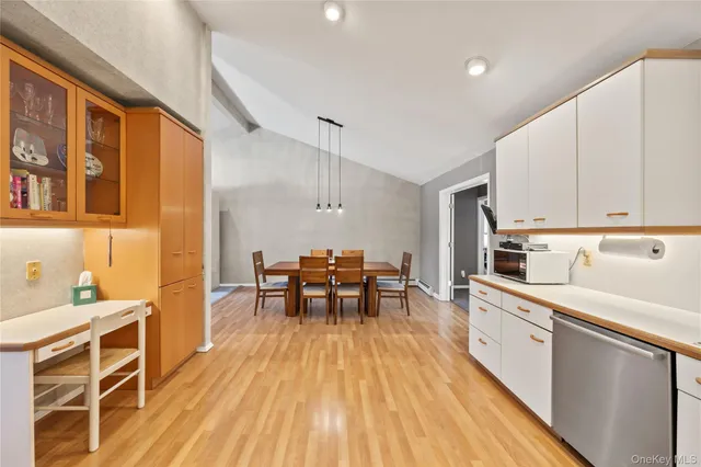 a kitchen with wooden floors and wooden cabinets