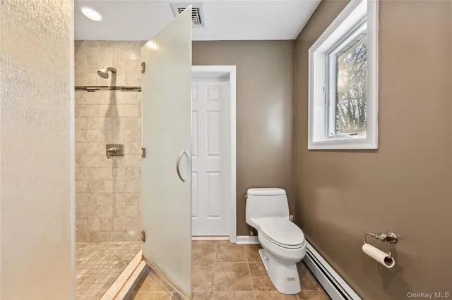 a white toilet sitting next to a bathroom sink