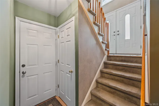 a view of entryway with wooden floor and stairs