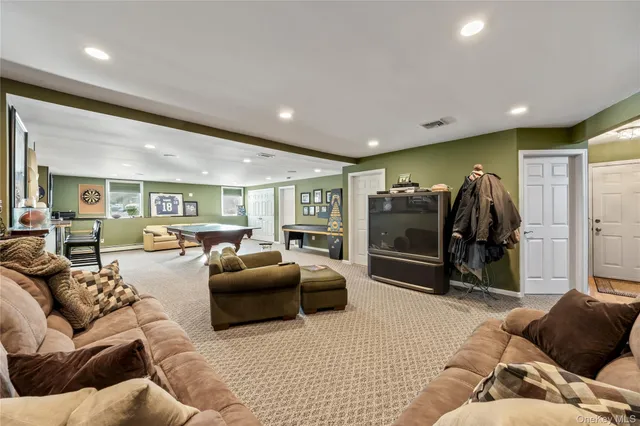 a living room with furniture and a ceiling fan