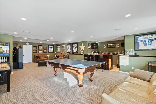 a living room with lots of furniture and kitchen view