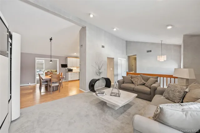 a living room with furniture and a chandelier