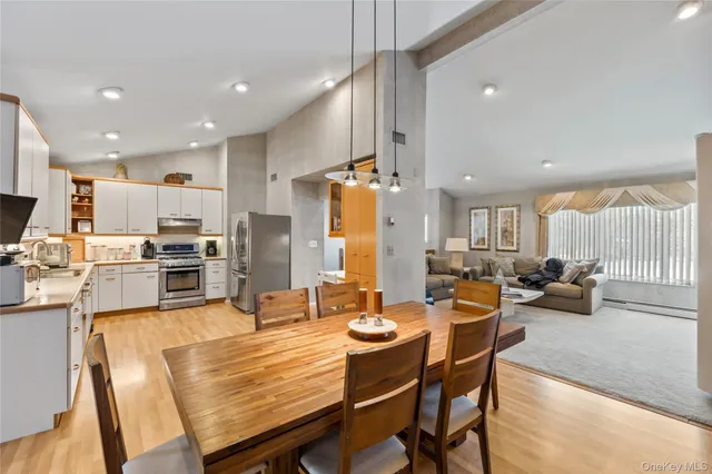 a large kitchen with a table and chairs