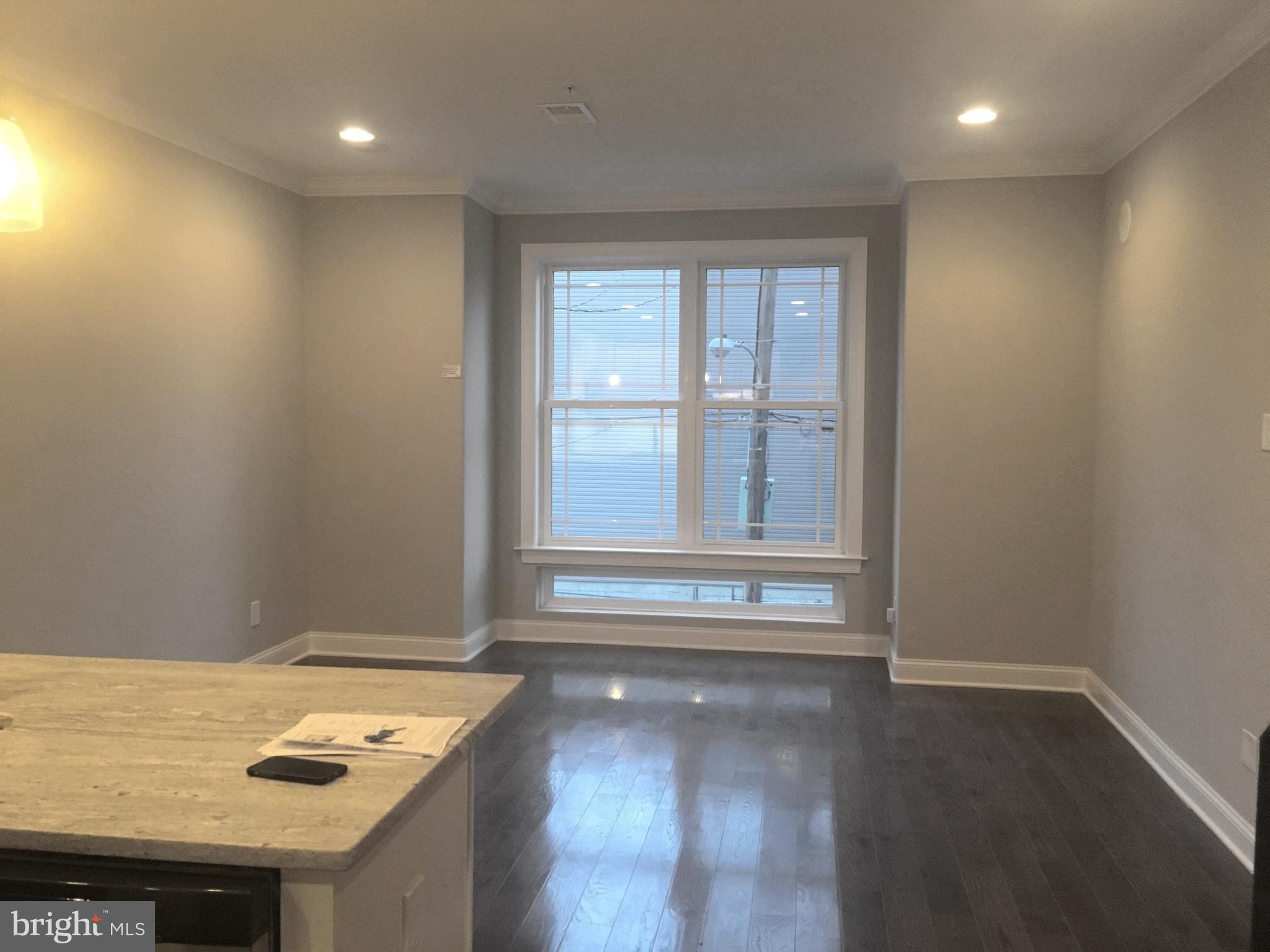 742-00 Master Street, Unit 2 Philadelphia, PA 19122 - Photo 16 of 17 an empty room with wooden floor and window