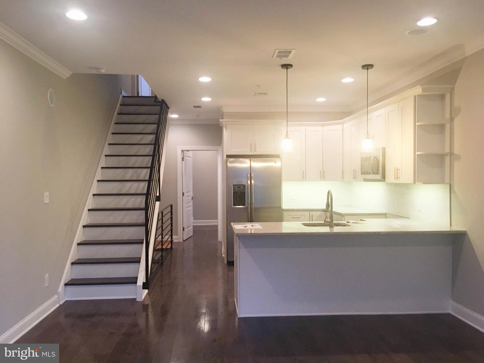 742-00 Master Street, Unit 2 Philadelphia, PA 19122 - Photo 17 of 17 a kitchen with kitchen island granite countertop a sink and a refrigerator