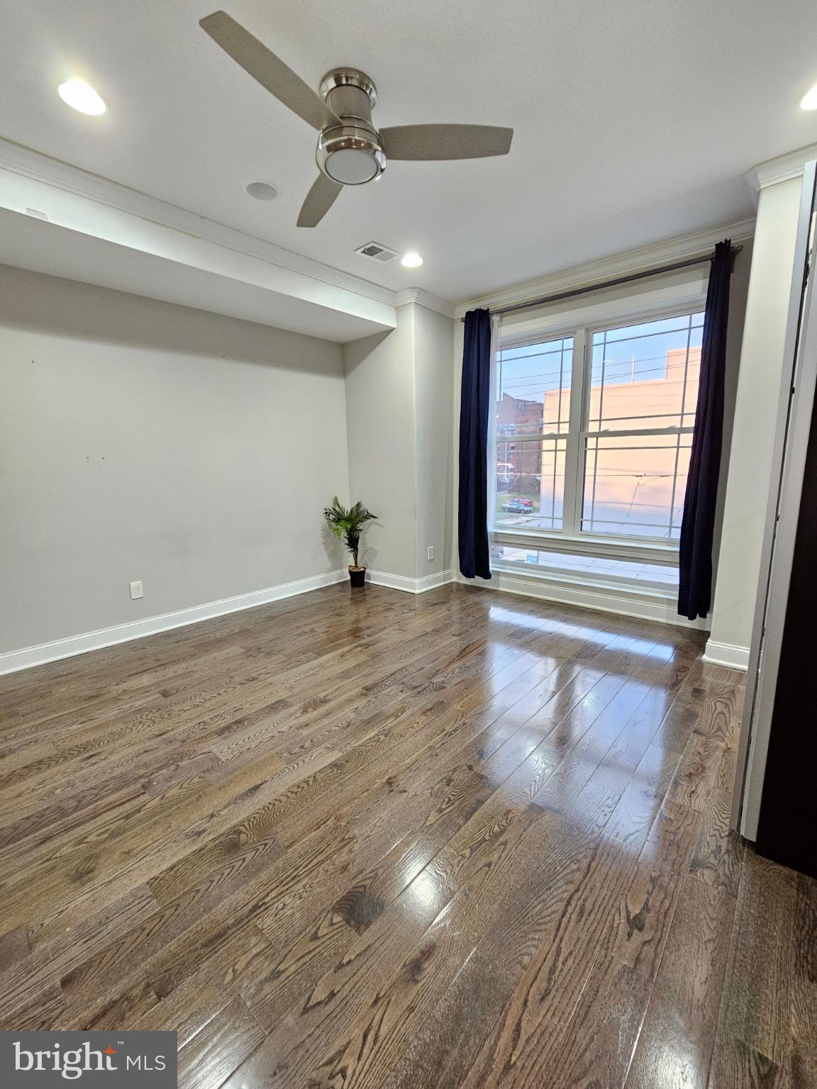 742-00 Master Street, Unit 2 Philadelphia, PA 19122 - Photo 4 of 17 a view of an empty room with a window and wooden floor