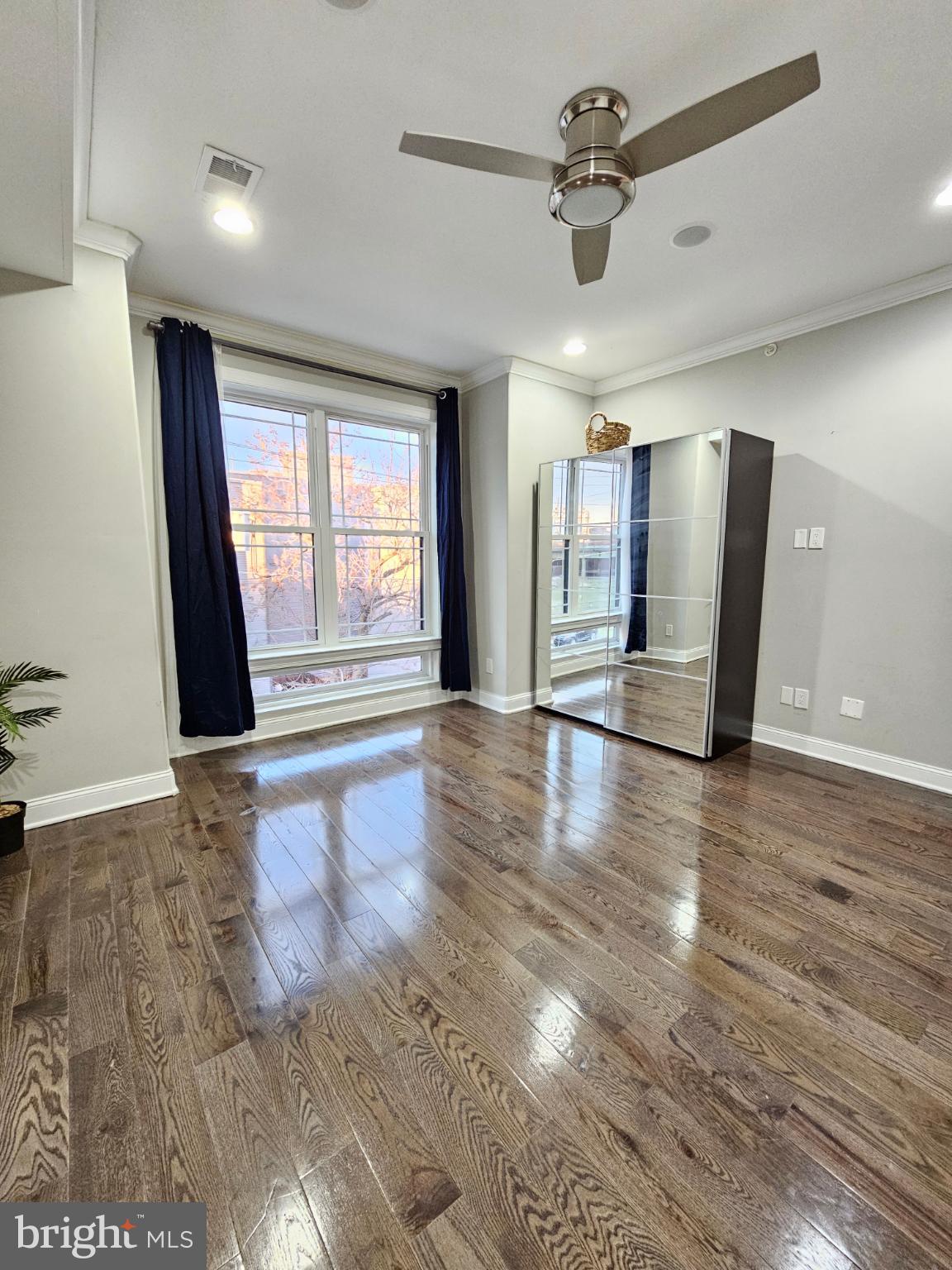 742-00 Master Street, Unit 2 Philadelphia, PA 19122 - Photo 5 of 17 an empty room with wooden floor and windows