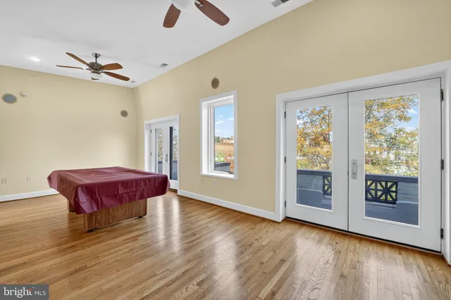 a spacious bedroom with a bed and wooden floor