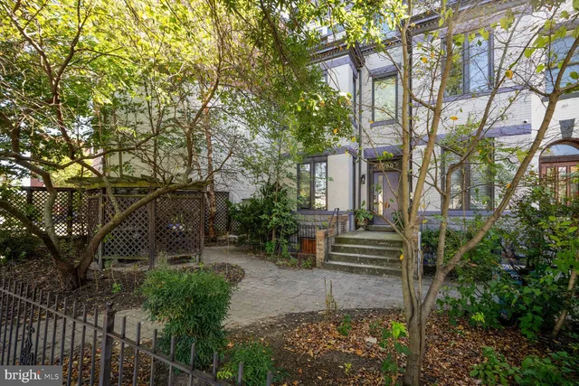 a front view of a house with a garden