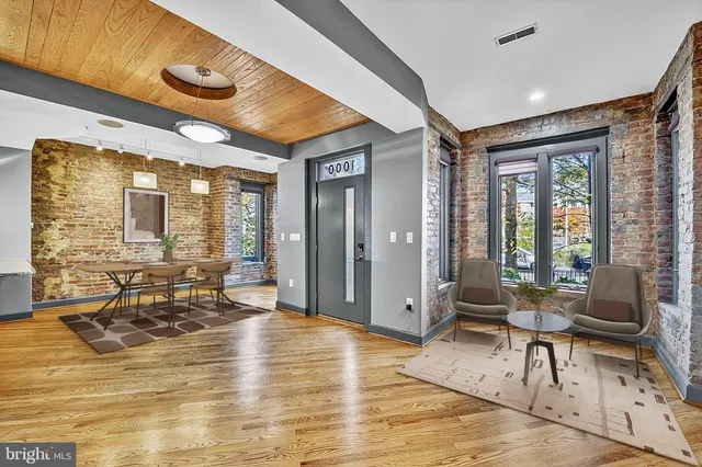 a living room filled with furniture hardwood floor and a large window