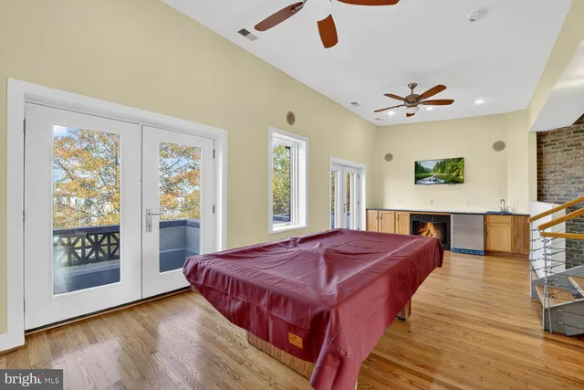 a spacious bedroom with a bed and wooden floor