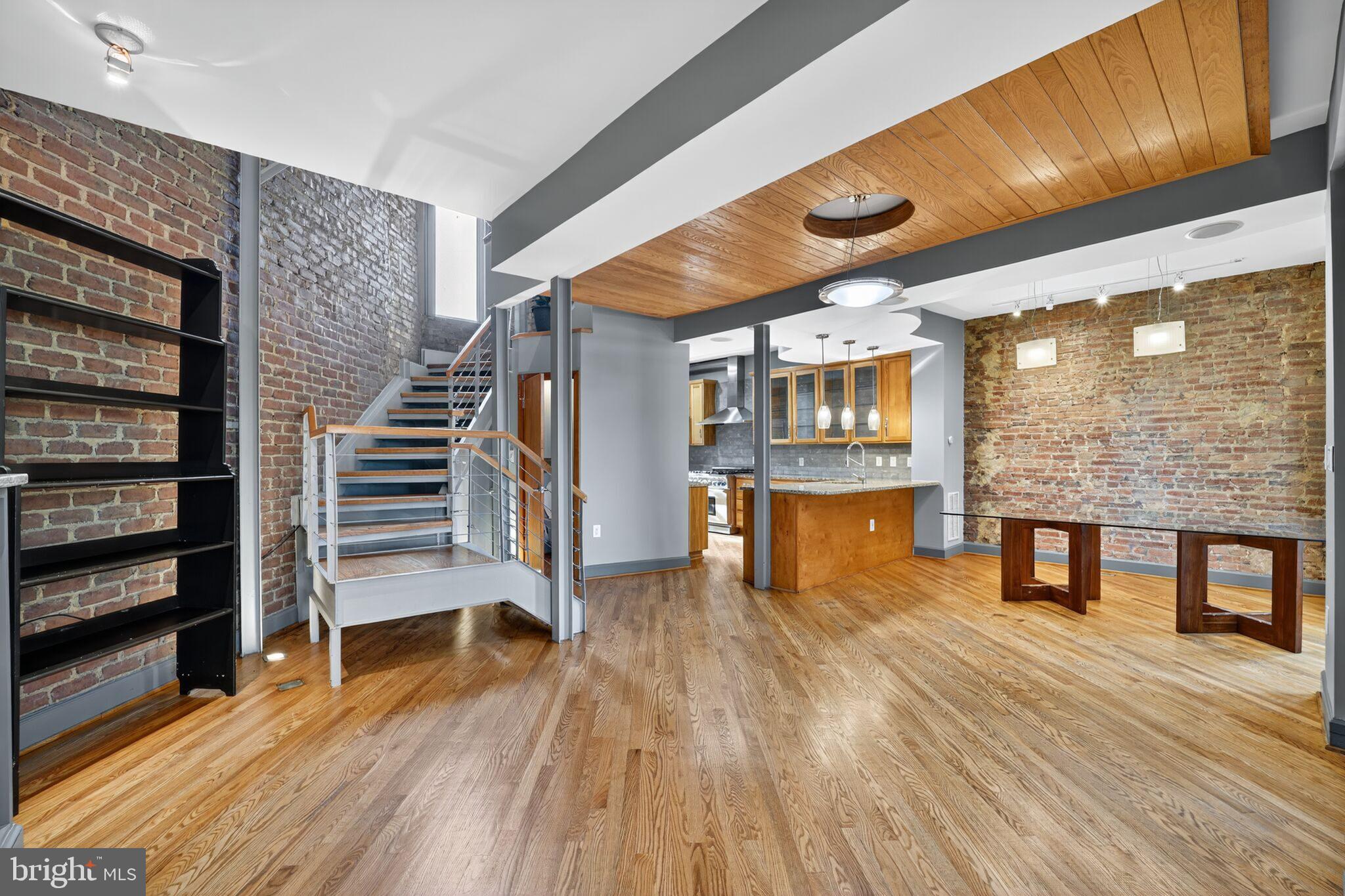 1000 Park Road Northwest Washington, DC 20010 - Photo 10 of 30 a view of an empty room with wooden floor and windows