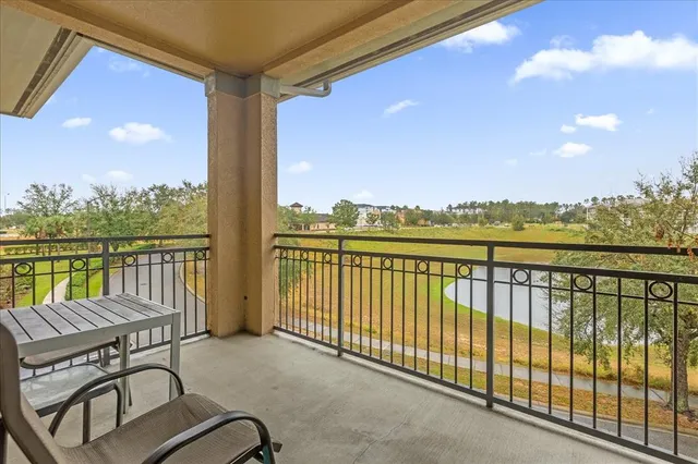 a view of a balcony with chair and wooden floor
