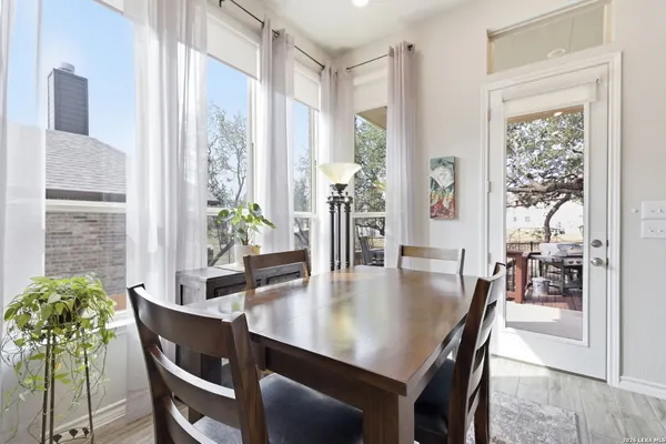 a view of a dining room with furniture and a potted plant