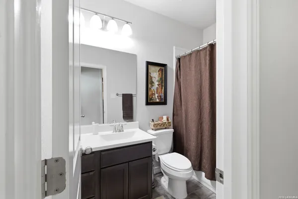 a bathroom with a sink toilet and mirror