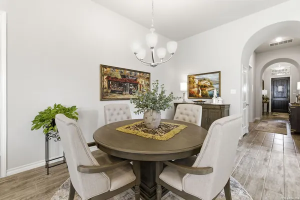 a view of a dining room with furniture and wooden floor