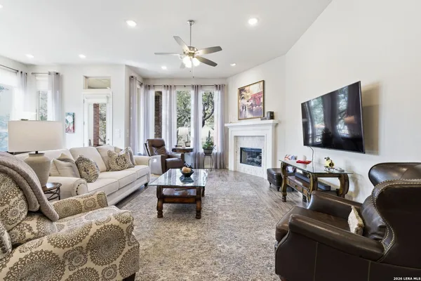 a living room with furniture fireplace and flat screen tv
