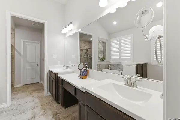 a bathroom with double sink and a mirror