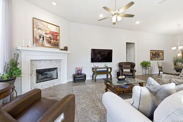 a living room with furniture a fireplace and a flat screen tv