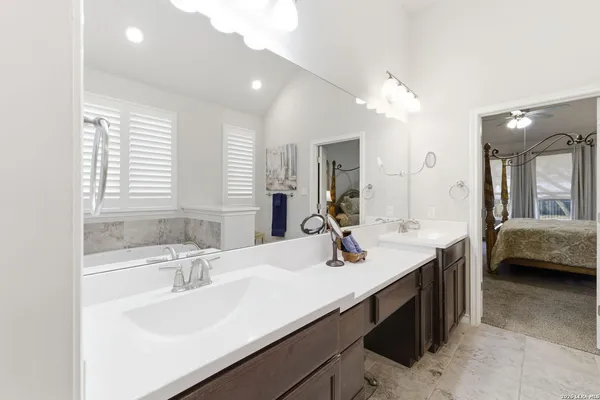 a en suite bathroom with a sink double vanity and a mirror