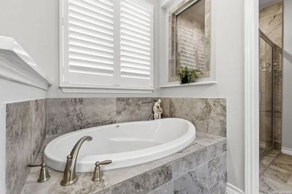 a bath tub sitting in a bathroom next to a window
