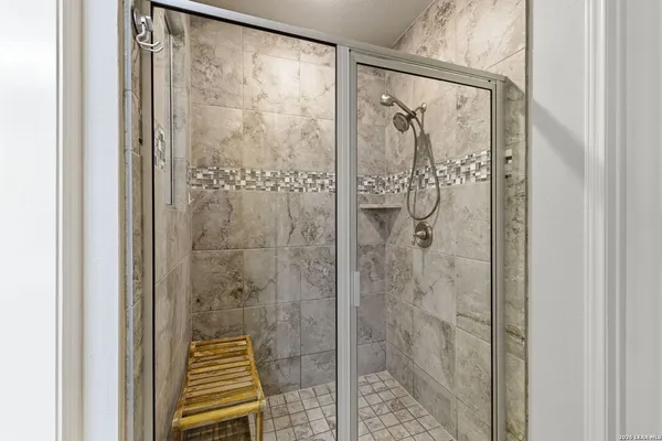 a bathroom with a shower and a sink