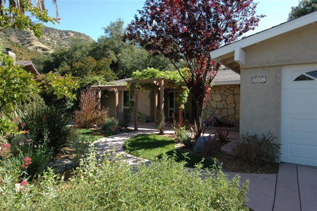 1402 Daly Road Ojai, CA 93023 - Photo 1 of 7 a view of a house with a yard and garden