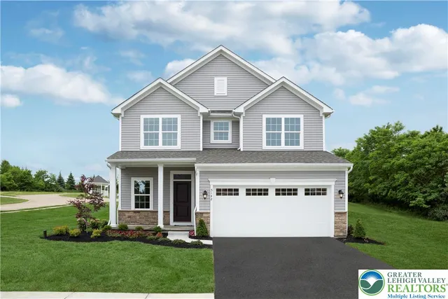 a front view of a house with a yard and trees