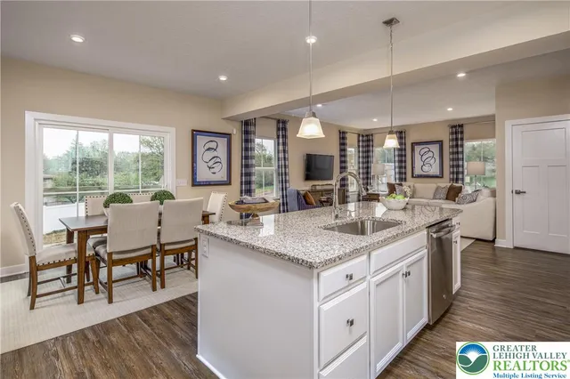 a kitchen with center island and wooden floors