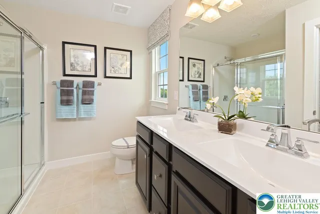 a bathroom with a granite countertop sink a toilet and a mirror