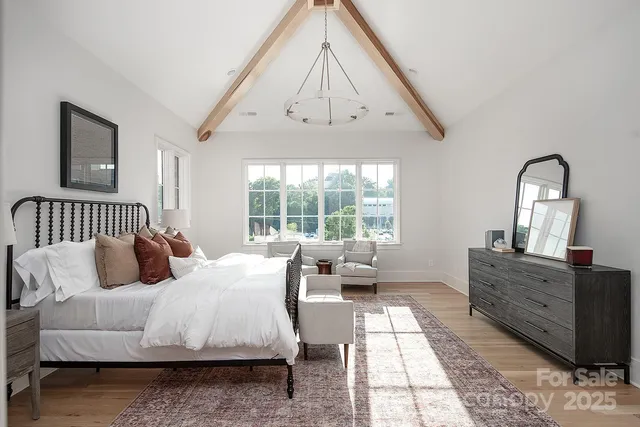 a bed room with a bed and a mirror