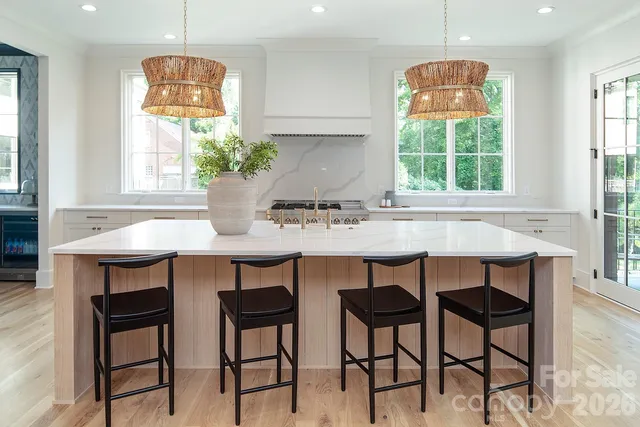 a large kitchen with stainless steel appliances kitchen island granite countertop a sink and cabinets