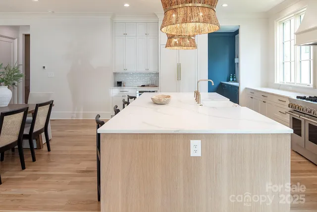 a kitchen with a sink a stove and chairs