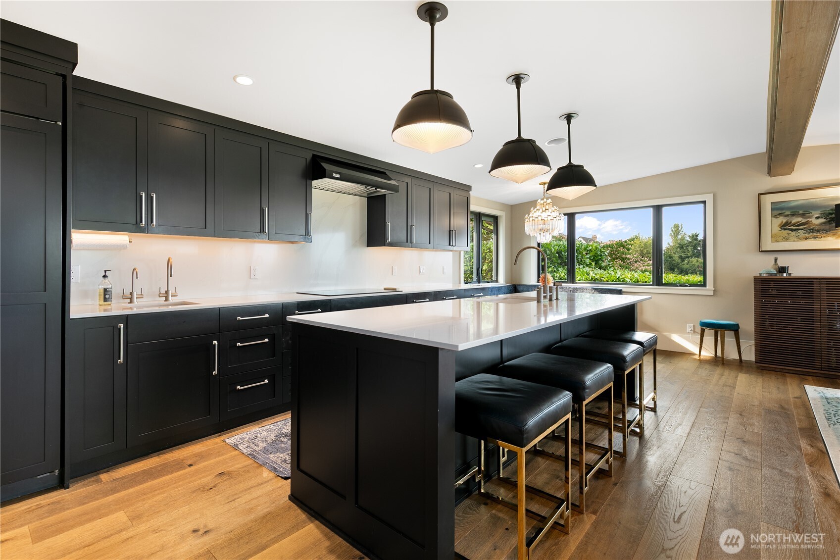 2816 South Hudson Street Seattle, WA 98108 - Photo 12 of 40 a kitchen with stainless steel appliances granite countertop wooden cabinets a stove a sink a dining table and chairs